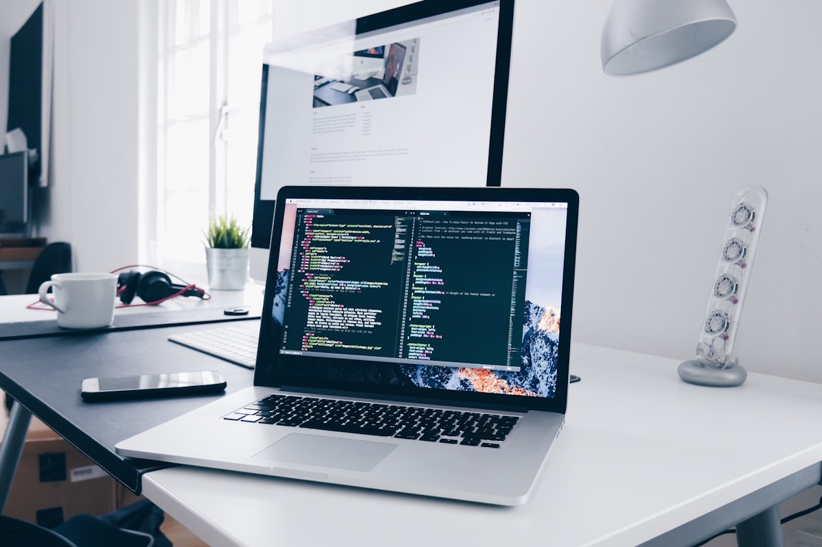Laptop displaying code in a home office setup